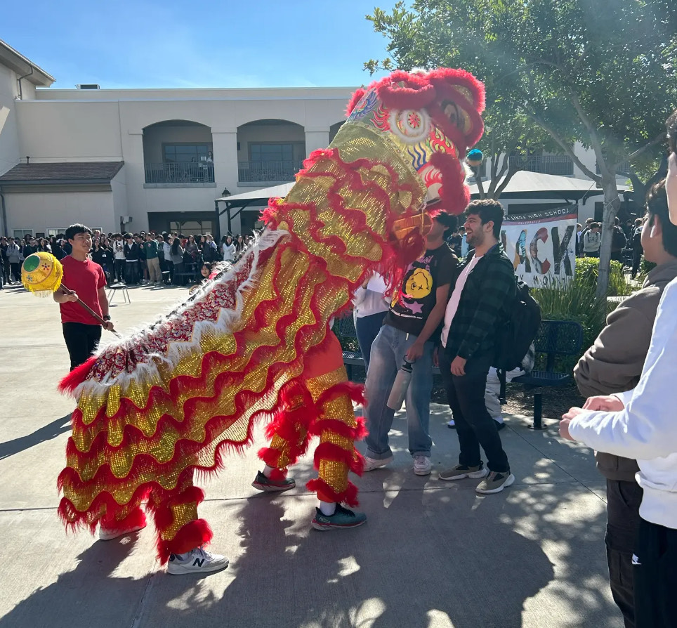 YLHS’s Chinese class students perform the traditional lion dance in the quad during break.