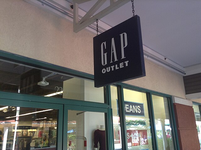 GAP jeans have soared in popularity ever since their collaboration with Katseye. Gap Outlet Store by Mike Mozart is licensed under CC BY 2.0.