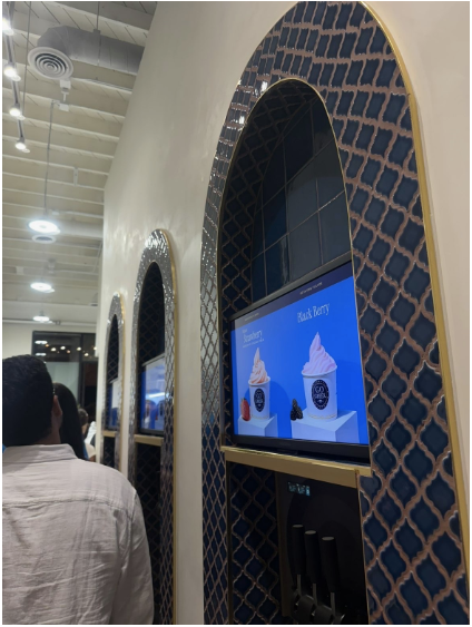 Digital screens displaying flavors at Go Greek for customers to choose from. 