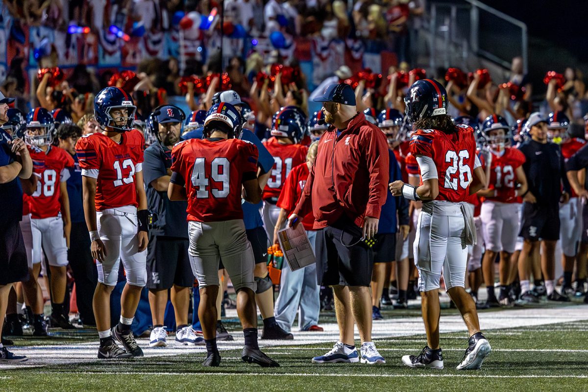 The Stable, adorned in red, white, and blue, cheers on the football team in their game against Tustin High School.