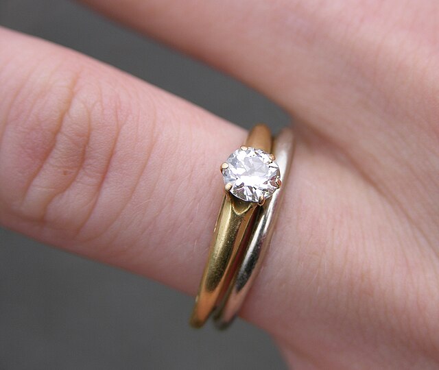 Engagement rings are symbols of love and commitment. Wedding and Engagement Rings by Derek Ramsey is licensed under CC BY-SA 2.5.