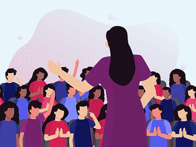 Stress and fear are natural responses to public speaker for many; however, with the right strategies, nervousness can be transformed into confidence. Woman speaking at an event by Delegate Connect Images is licensed under CC BY 2.0.