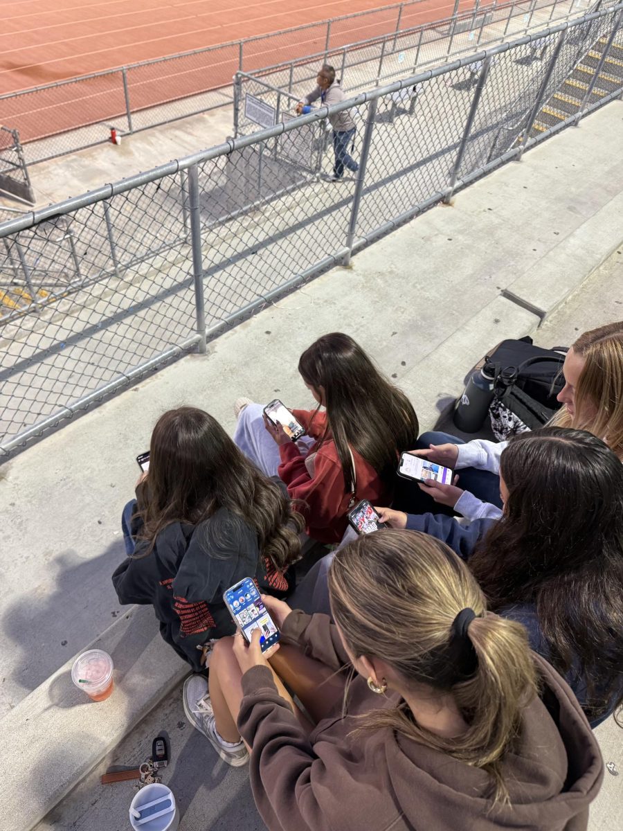 Group of teenagers glued to smartphones 

