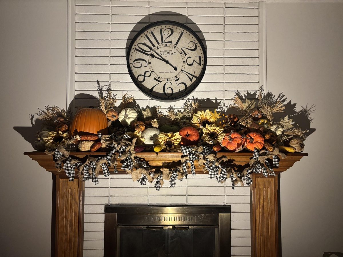 A fireplace covered in fall and Halloween