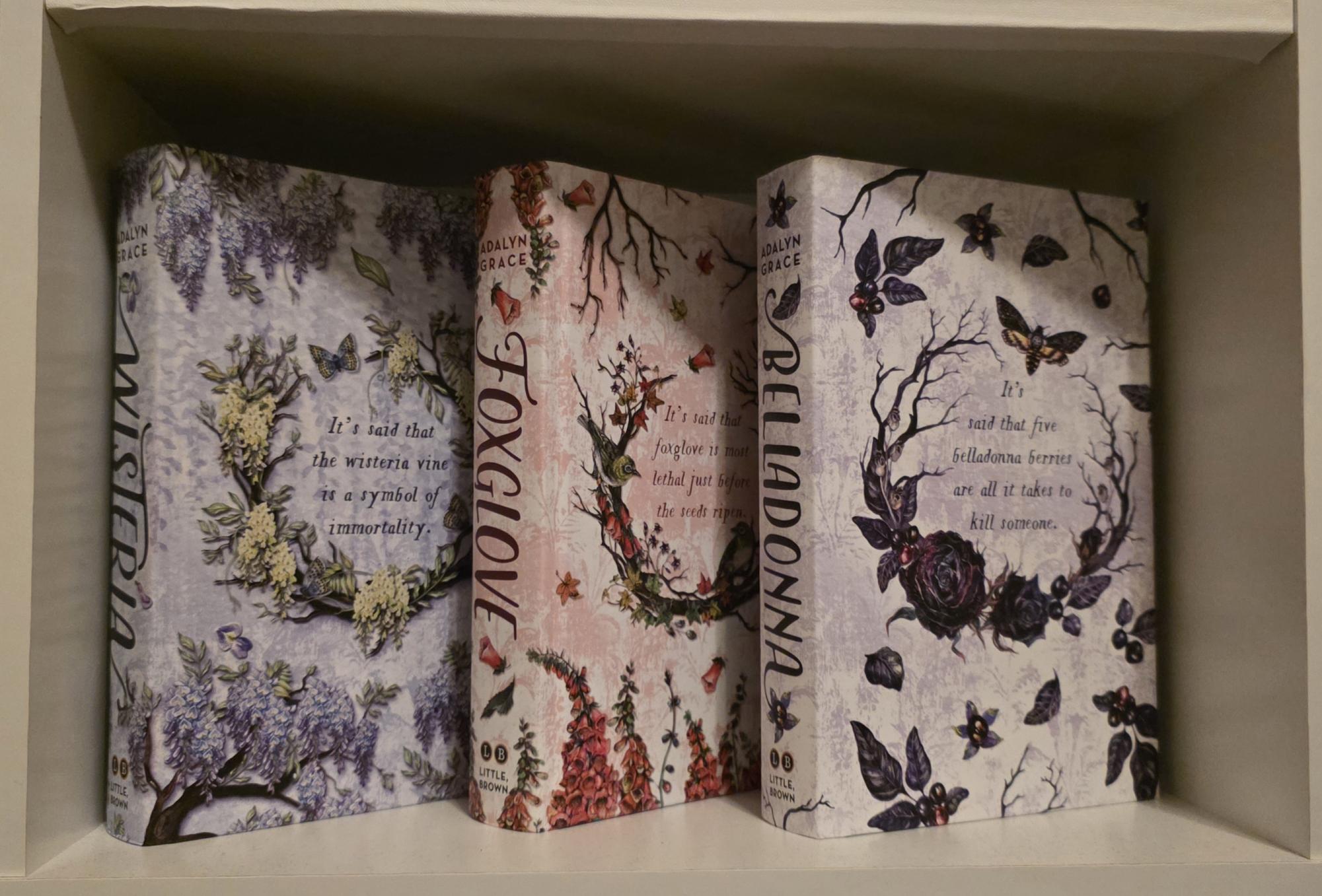 The case covers of the Belladonna by Adalyn Grace first editions, featuring a quote and the titular flower of each book. These covers are also available in the boxed set.