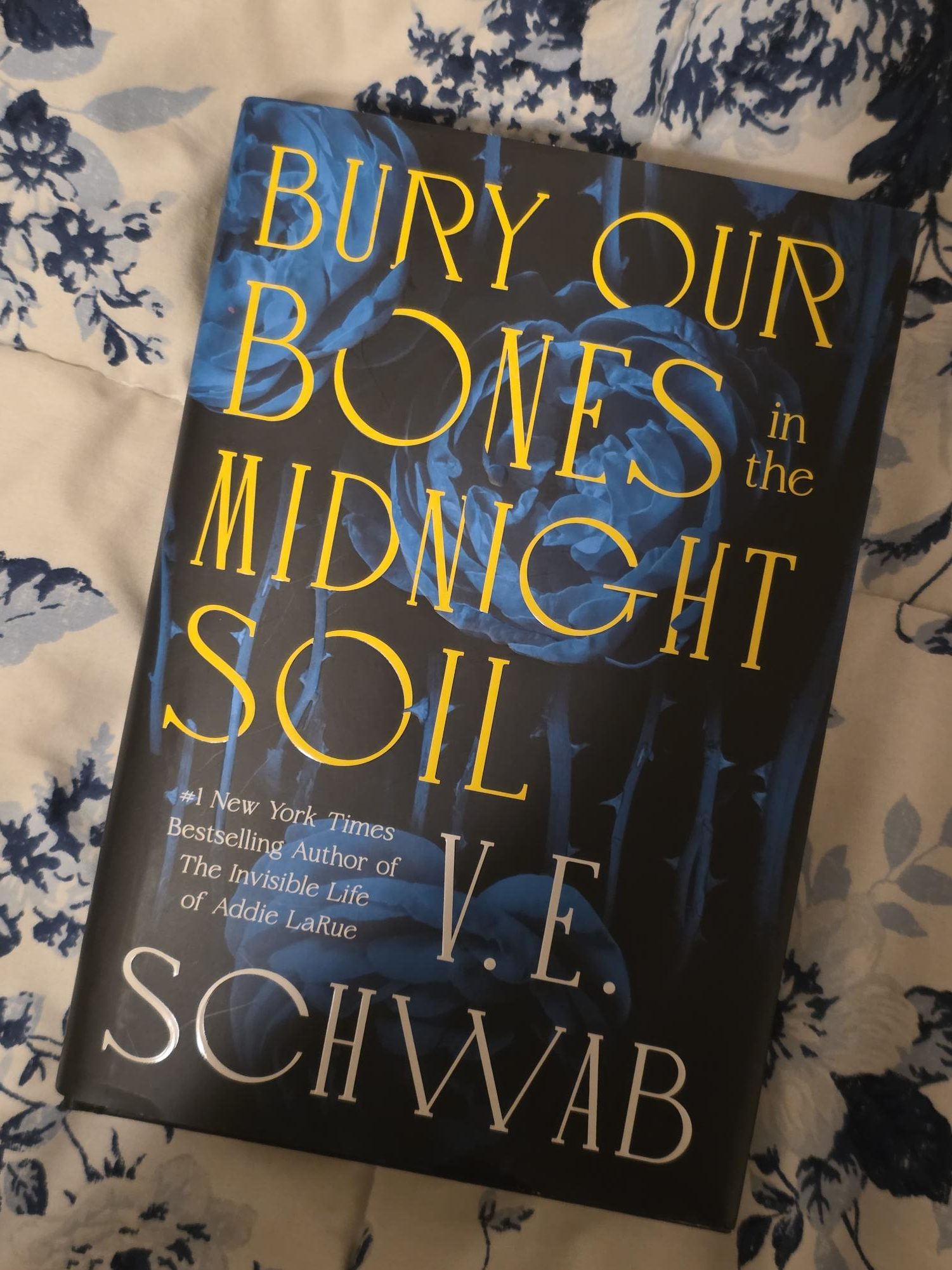 Bury Our Bones in the Midnight Soil by V.E. Schwab’s front cover, including roses and thorns that tie into the gothic and earthy title.