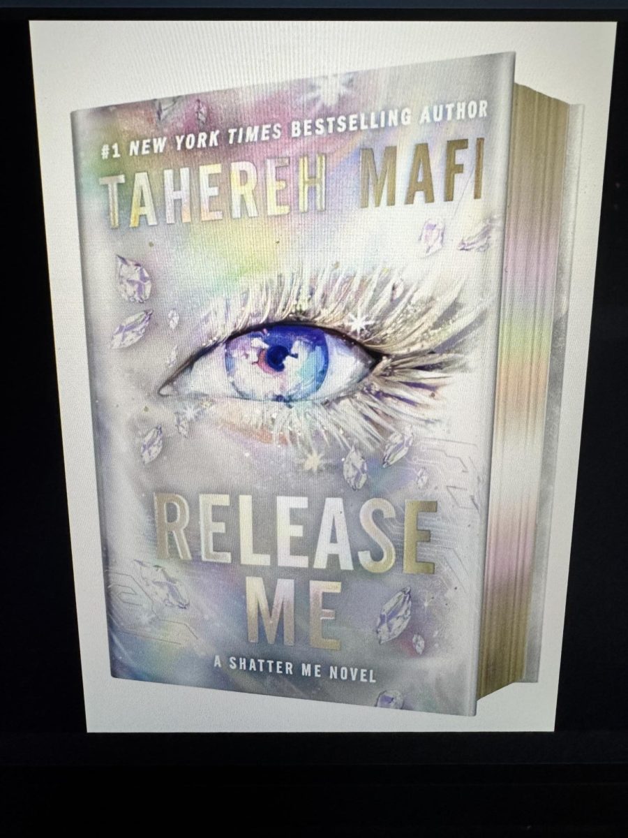 The deluxe limited edition of Release Me by Tahereh Mafi, featuring special sprayed edges, designed endpapers, and a foiled case cover.