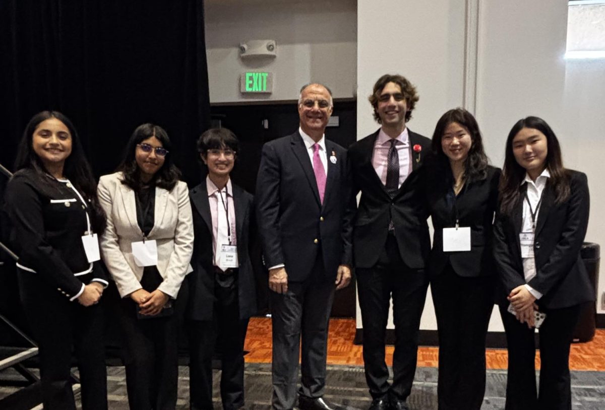 After the workshops, students were able to ask the speakers about any remaining questions they had. From left to right, Camilla Padilla (10), Isha Arya (10), Liana Bhindi (10), Lychee Li (10), and Kaley Fang (10) take a photo with two guest speakers: Dr. Giovanni Annous and Sebastien Annous (12).