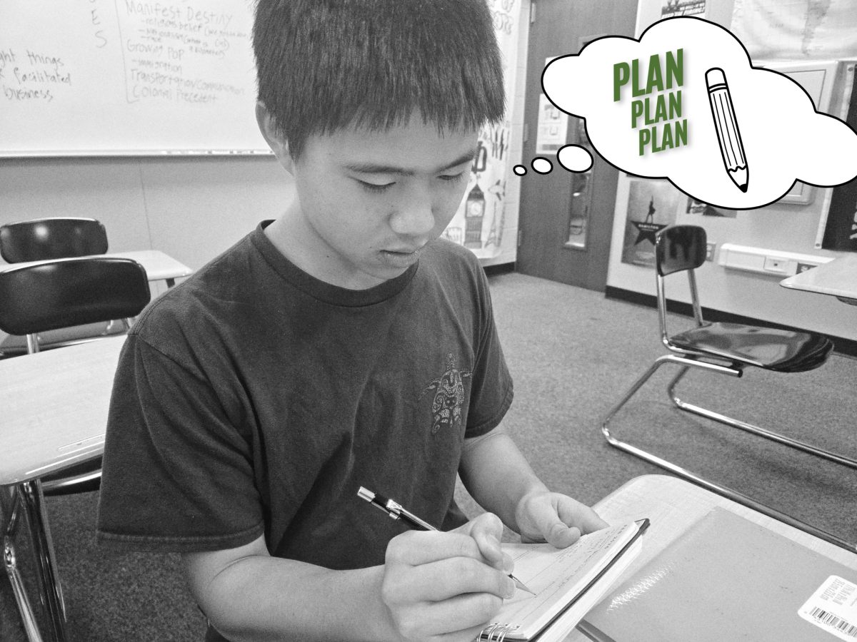 Aaodan Lee (11) quickly adds new homework assignments to his daily planner.