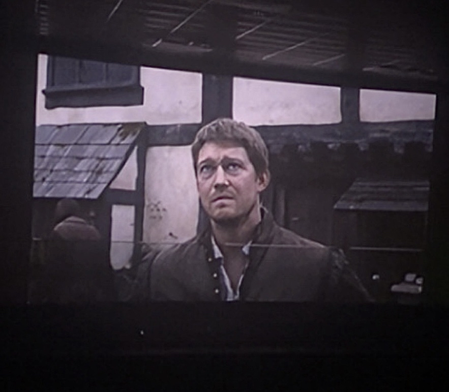 This depicts a scene from the movie Hamnet. The character portrayed is Bartholomew.
