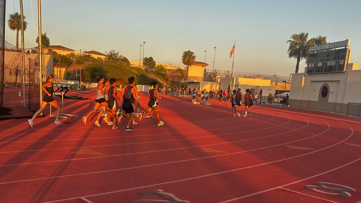 The combined boys and girls team battle it out in the grueling 3200 meter race.