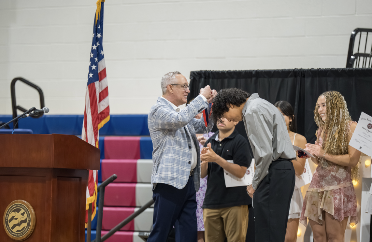A senior celebrates a memorable moment while receiving recognition at the Senior Awards Ceremony.